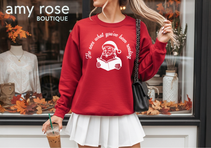 He Sees What You’ve Been Reading - Santa Reading Graphic, Red Funny Christmas Sweatshirt